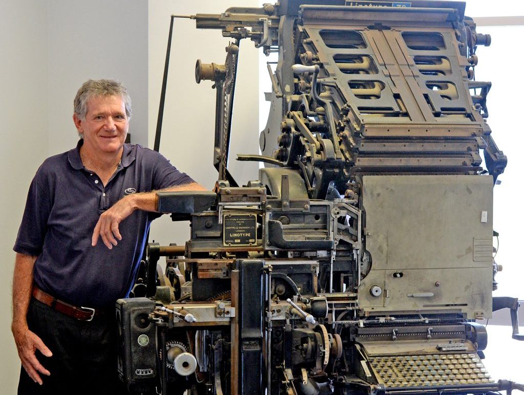 Brian Sutton with linotype machine once used in printing.